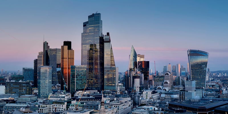 a city scape showing large buildings in the evening time